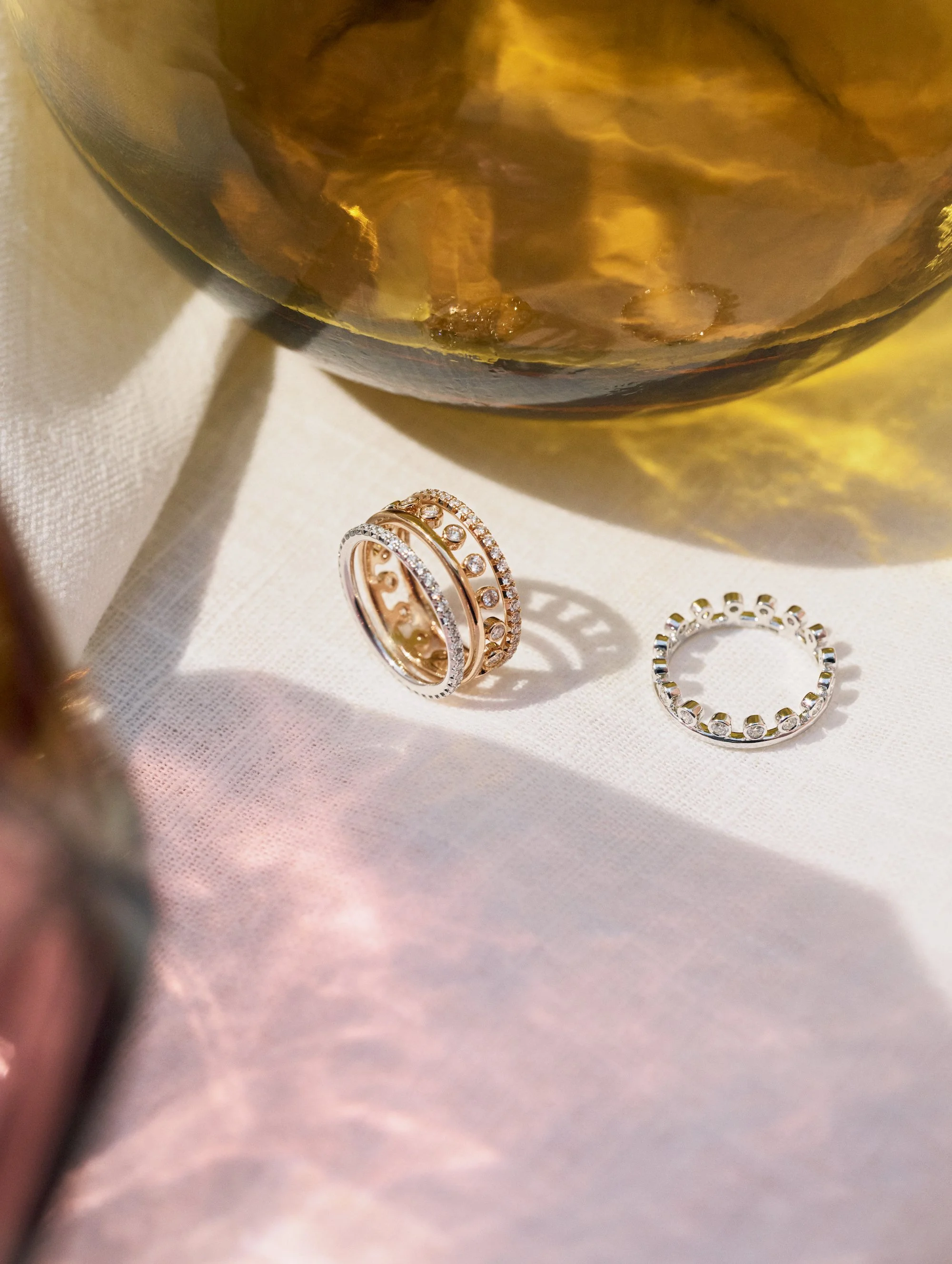 Product still life of gold rings with amber glass